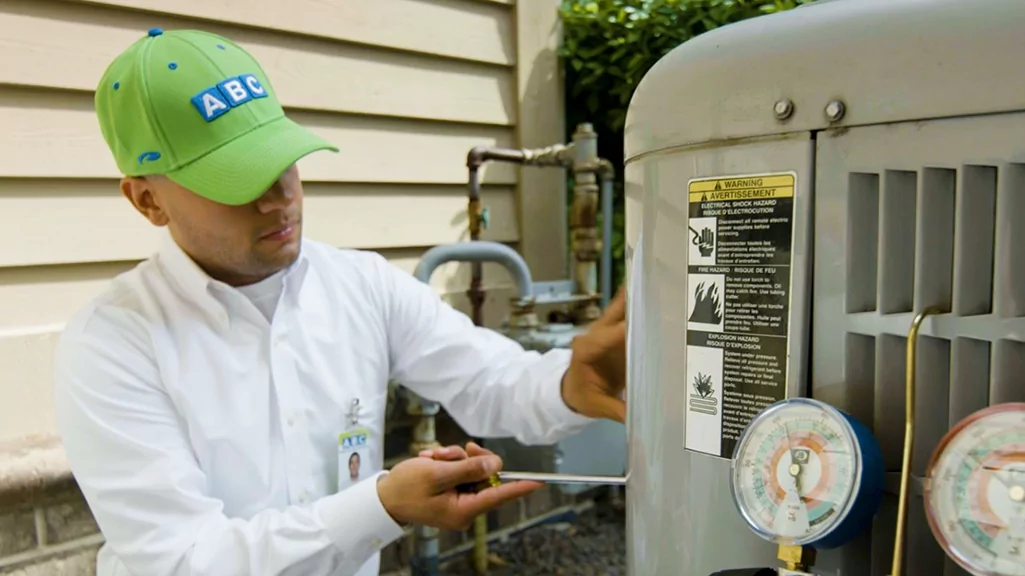 ABC technician repairing AC unit