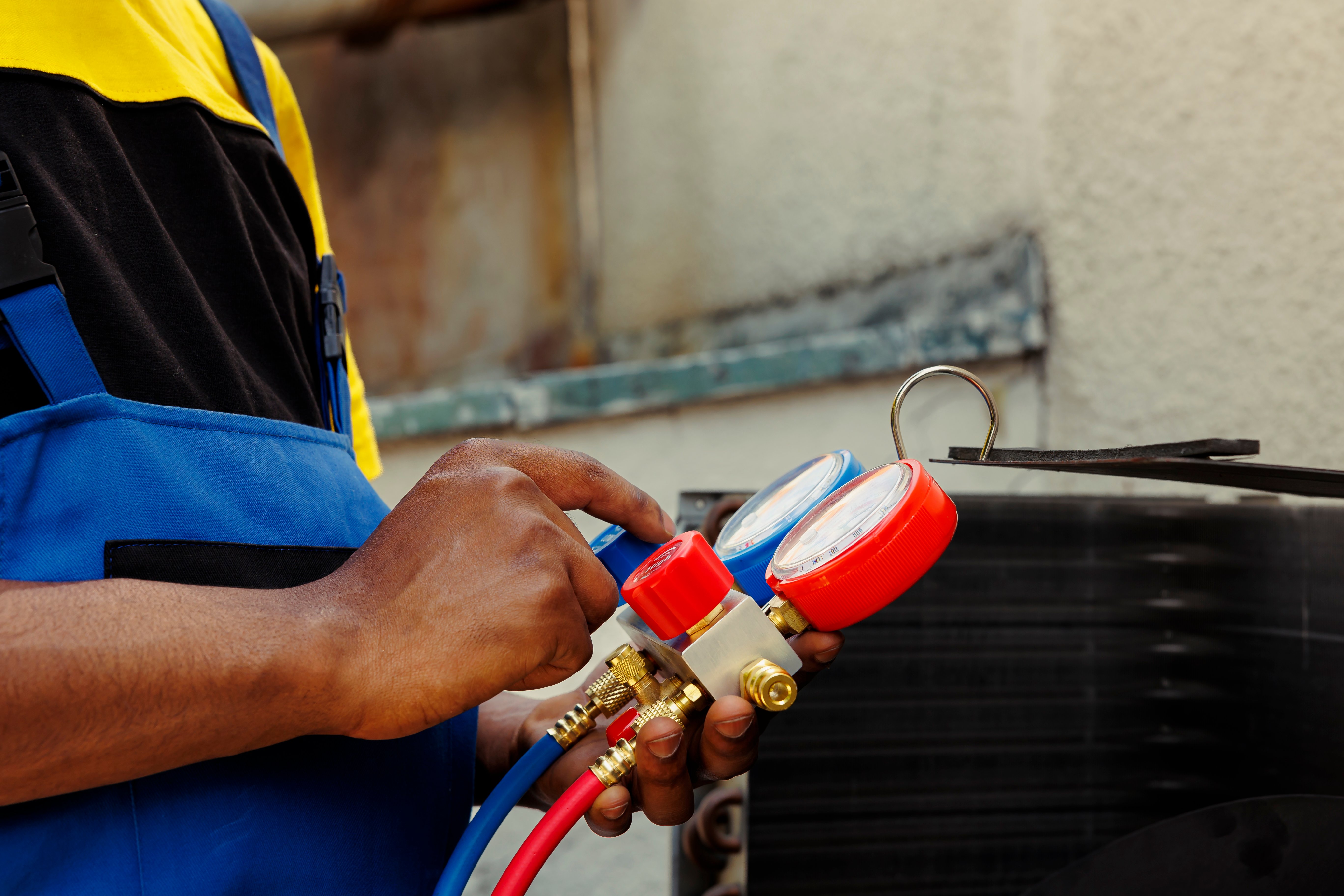 HVAC technician checking Freon levels