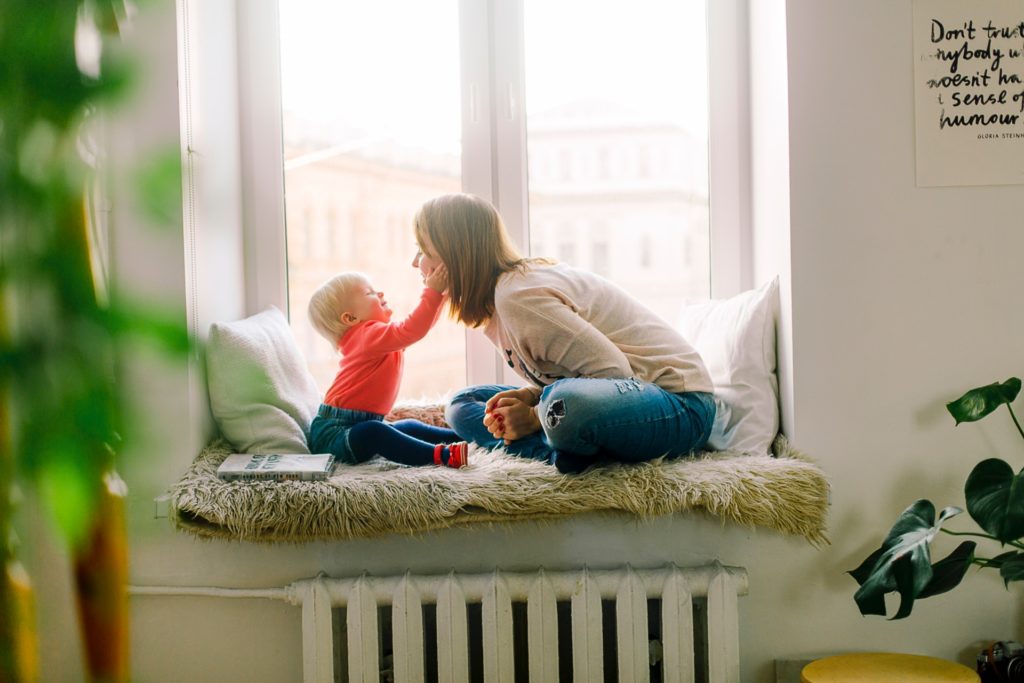 son & mother by window