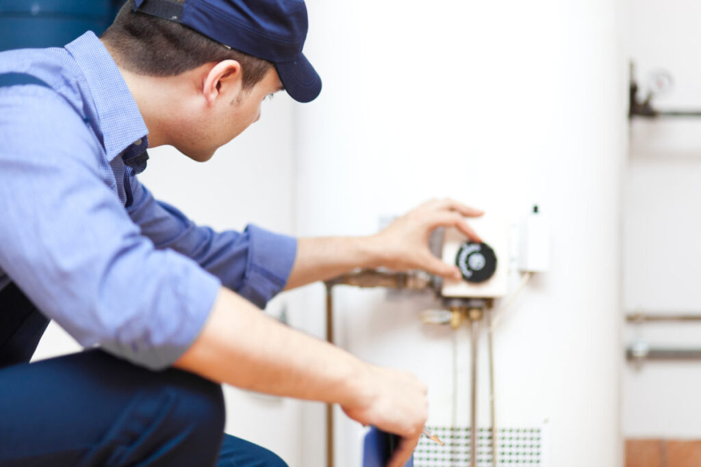 plumber in front of new water heater